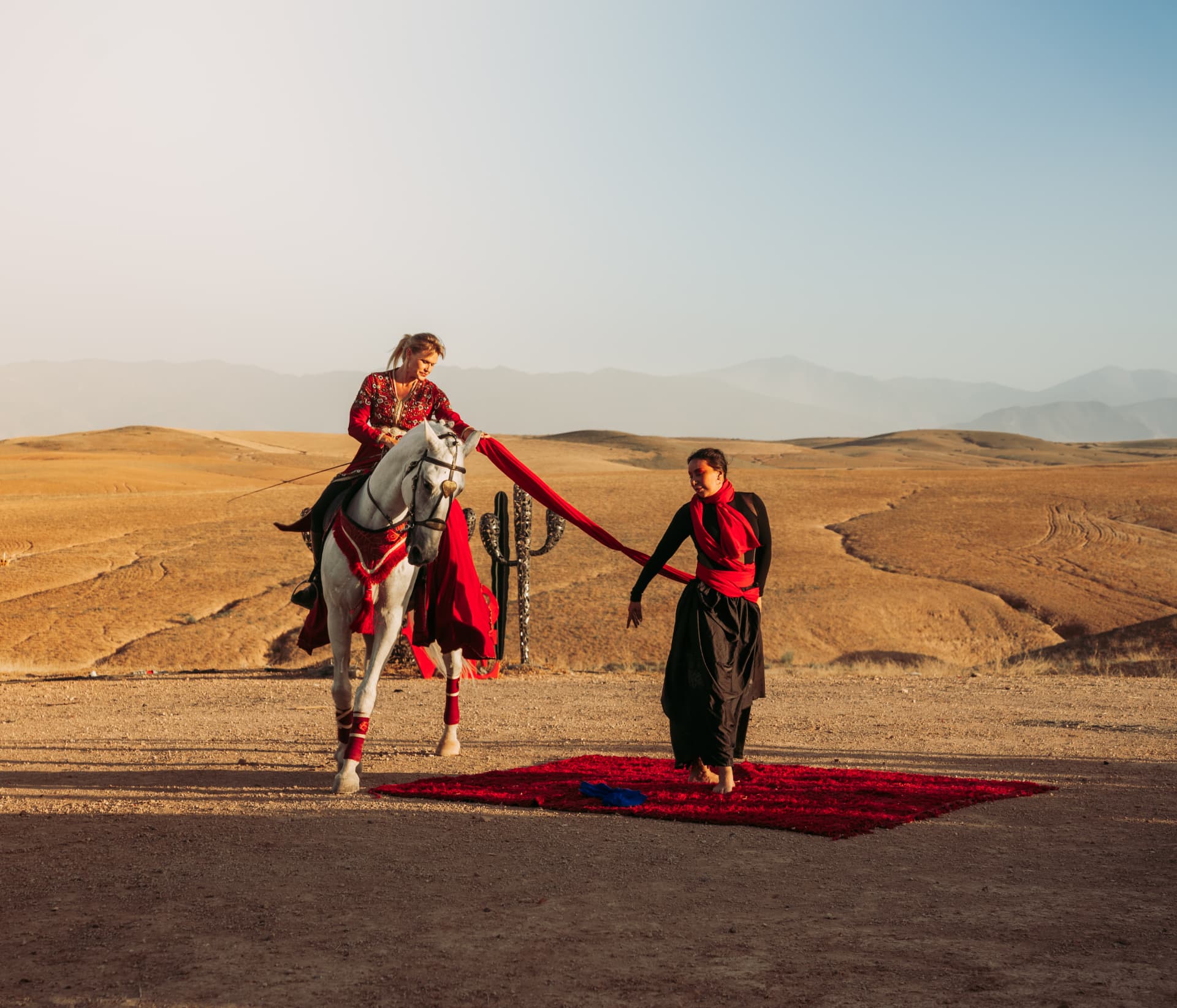 Celebration in the Agafay desert near Marrakech — equestrian performance in red, desert lounges, pampas tablescapes and fireworks, produced by SBAI Events Production