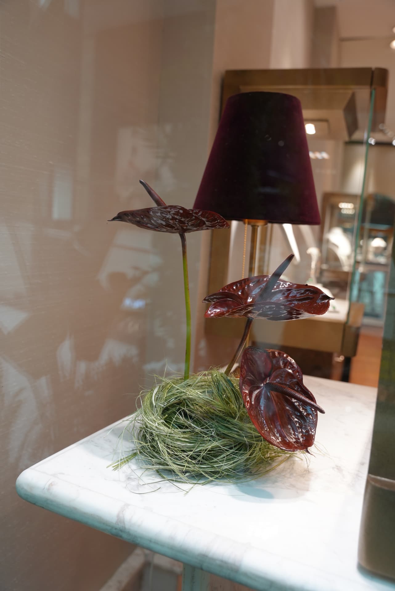 Kara.S boutique opening at Morocco Mall — burgundy anthurium and pink cymbidium installations, silver coupes and brass tables, produced by SBAI Events Production