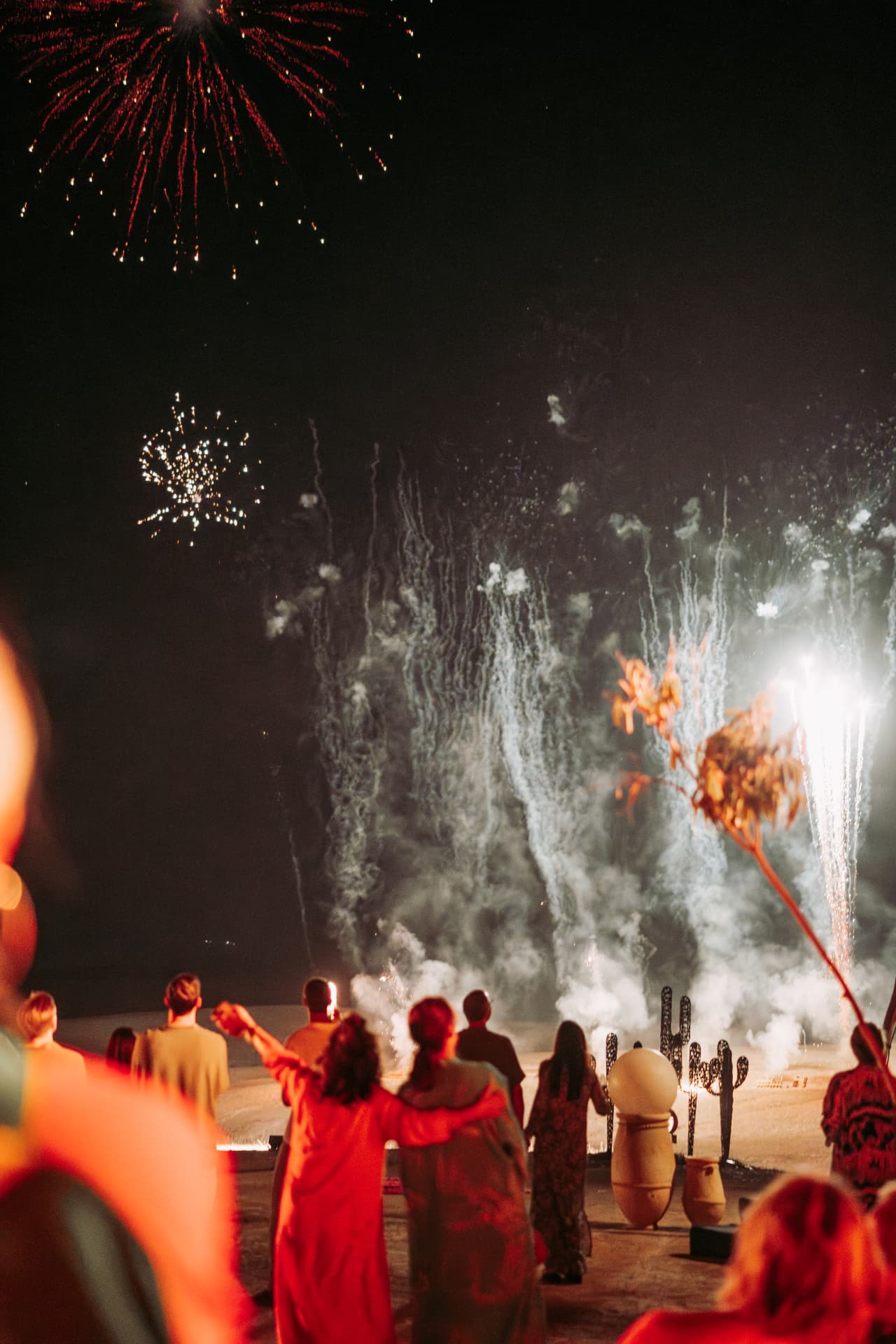 Celebration in the Agafay desert near Marrakech — equestrian performance in red, desert lounges, pampas tablescapes and fireworks, produced by SBAI Events Production