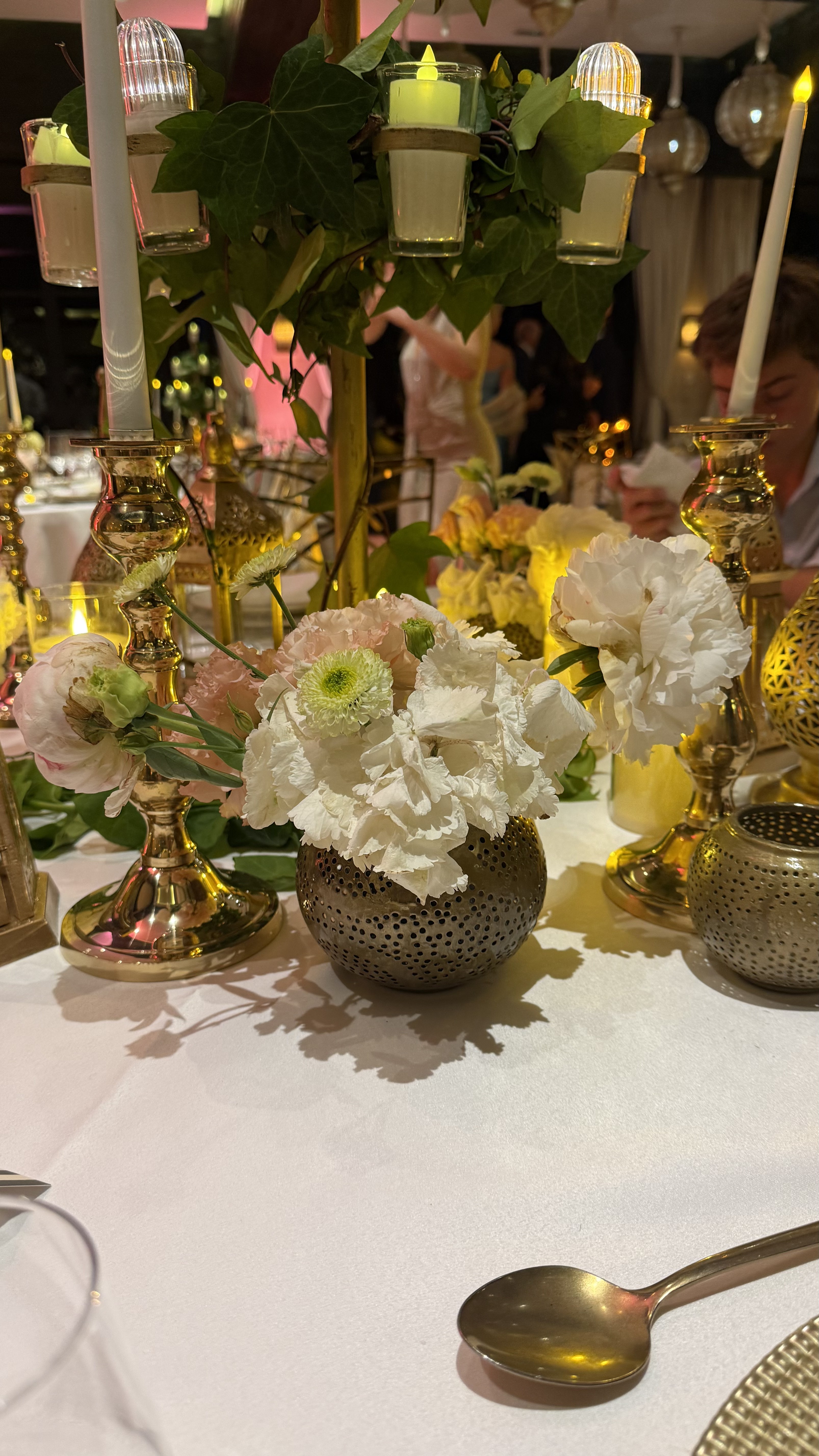 One Thousand and One Nights soirée at the Mandarin Oriental Marrakech — clouds of pierced brass lanterns, candlelit tablescapes and gold accents, produced by SBAI Events Production