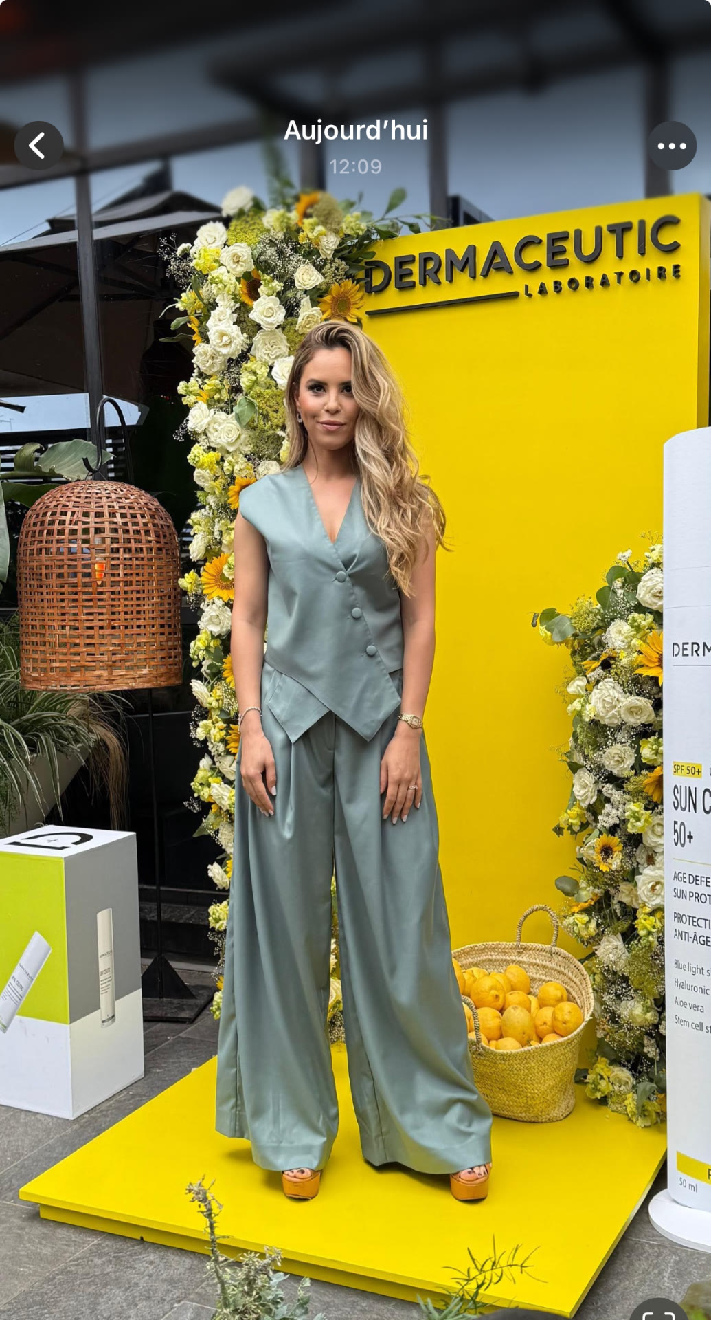 Dermaceutic product launch in Casablanca — yellow branded photo wall framed by white roses, sunflowers and lemon baskets, produced by SBAI Events Production