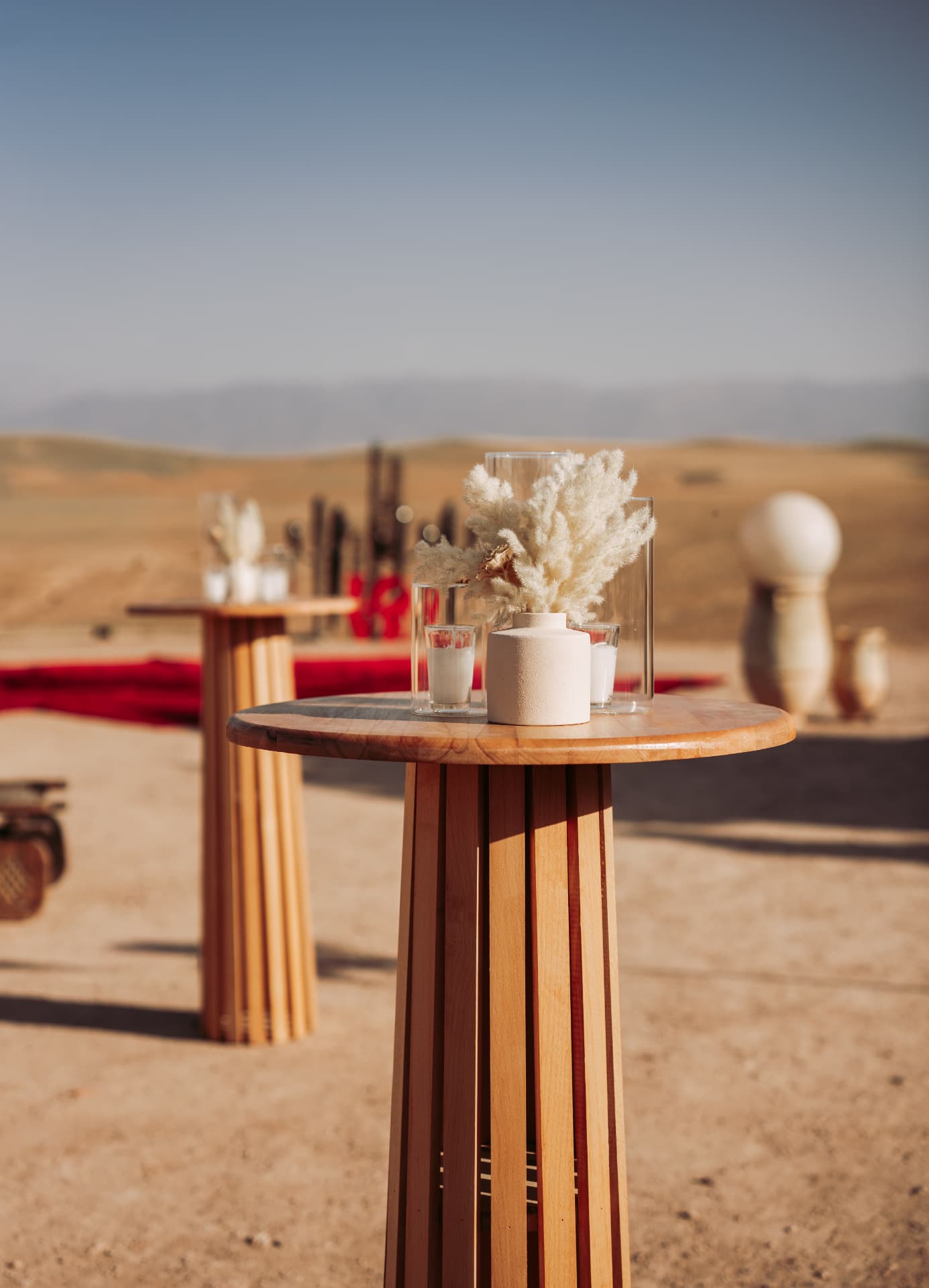 Celebration in the Agafay desert near Marrakech — equestrian performance in red, desert lounges, pampas tablescapes and fireworks, produced by SBAI Events Production