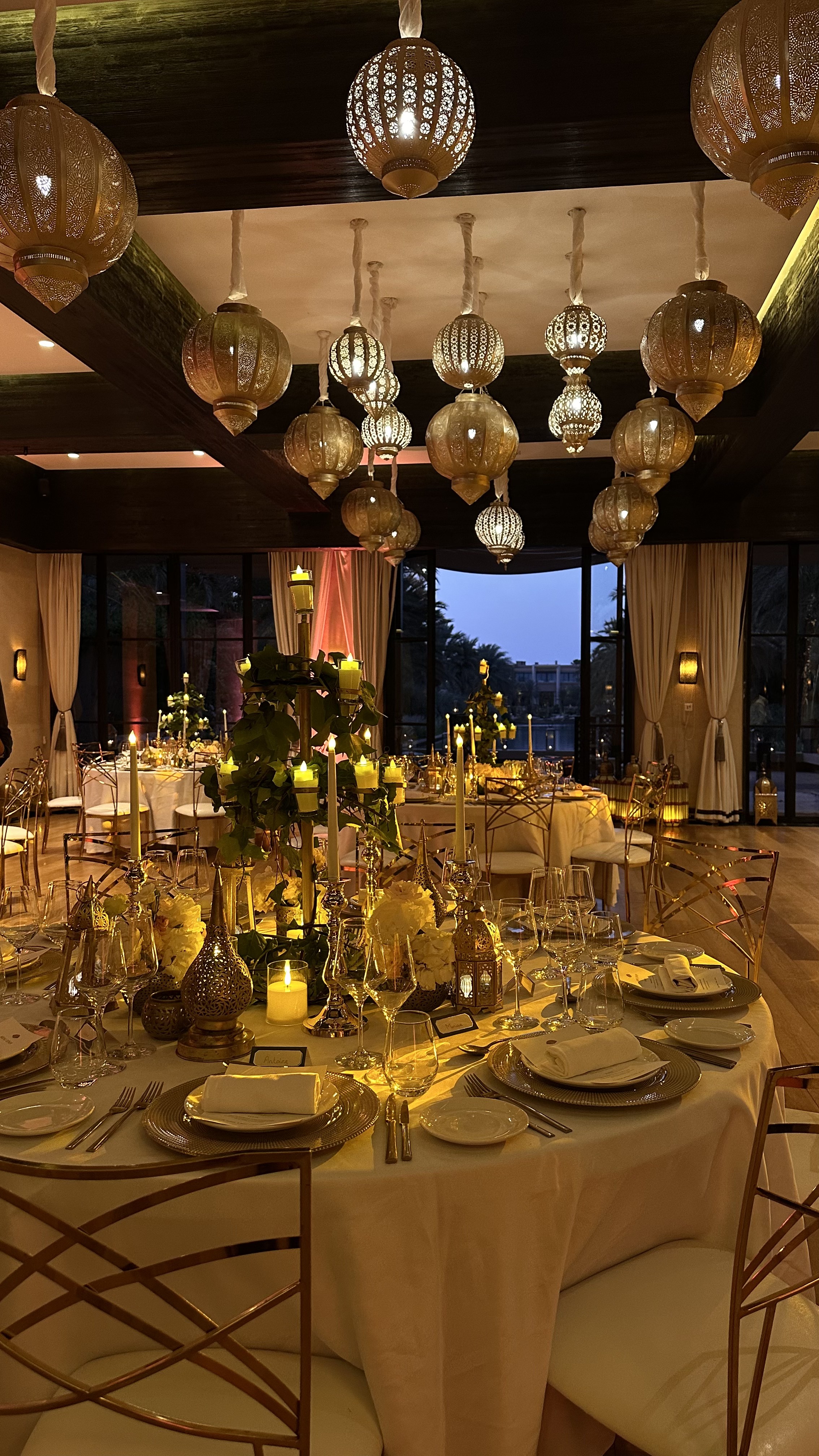One Thousand and One Nights soirée at the Mandarin Oriental Marrakech — clouds of pierced brass lanterns, candlelit tablescapes and gold accents, produced by SBAI Events Production