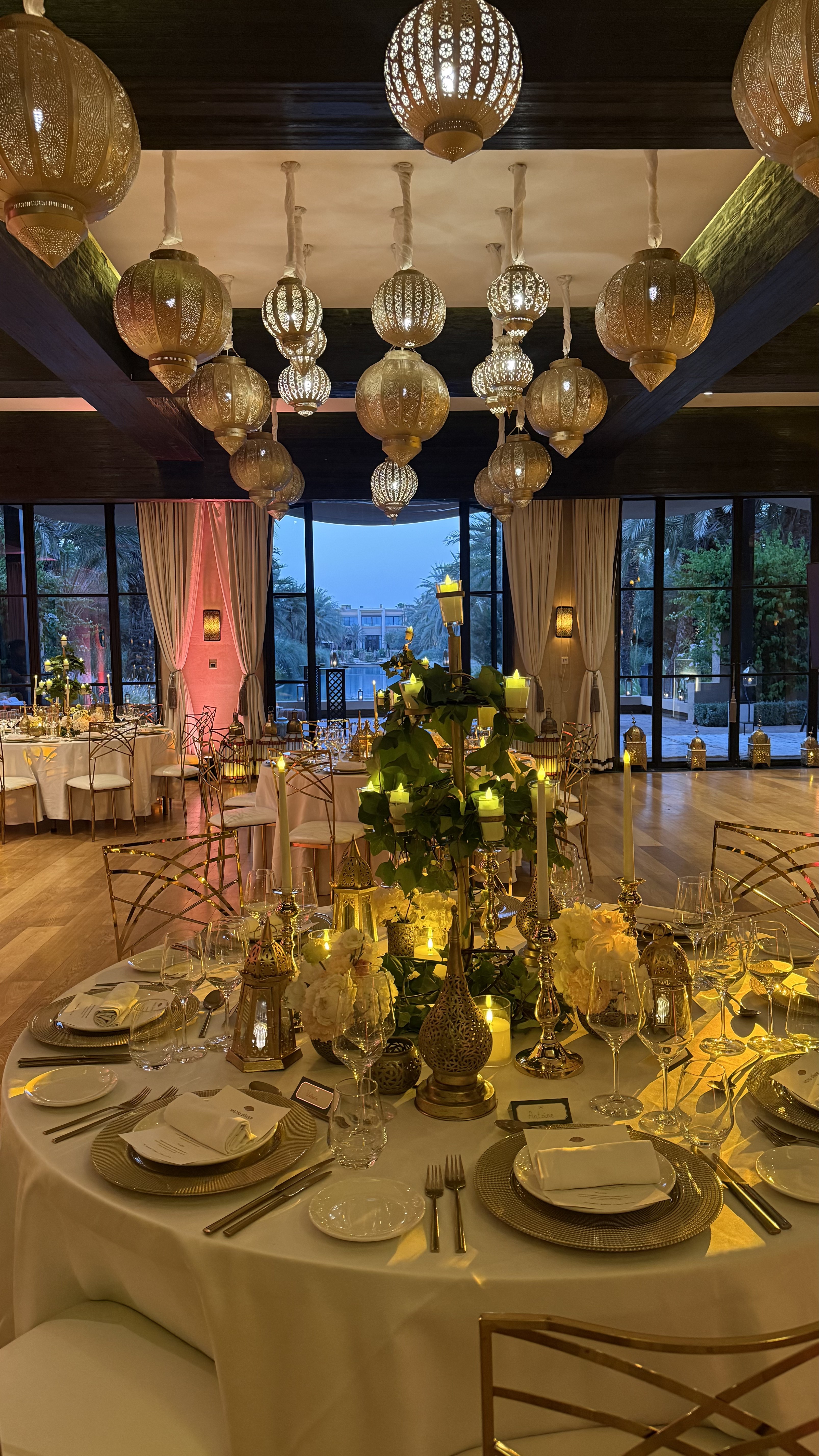 One Thousand and One Nights soirée at the Mandarin Oriental Marrakech — clouds of pierced brass lanterns, candlelit tablescapes and gold accents, produced by SBAI Events Production