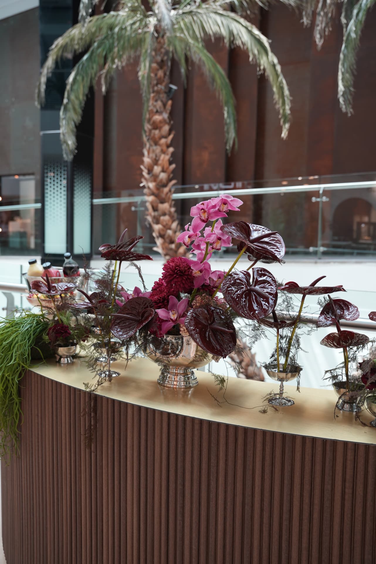 Kara.S boutique opening at Morocco Mall — burgundy anthurium and pink cymbidium installations, silver coupes and brass tables, produced by SBAI Events Production