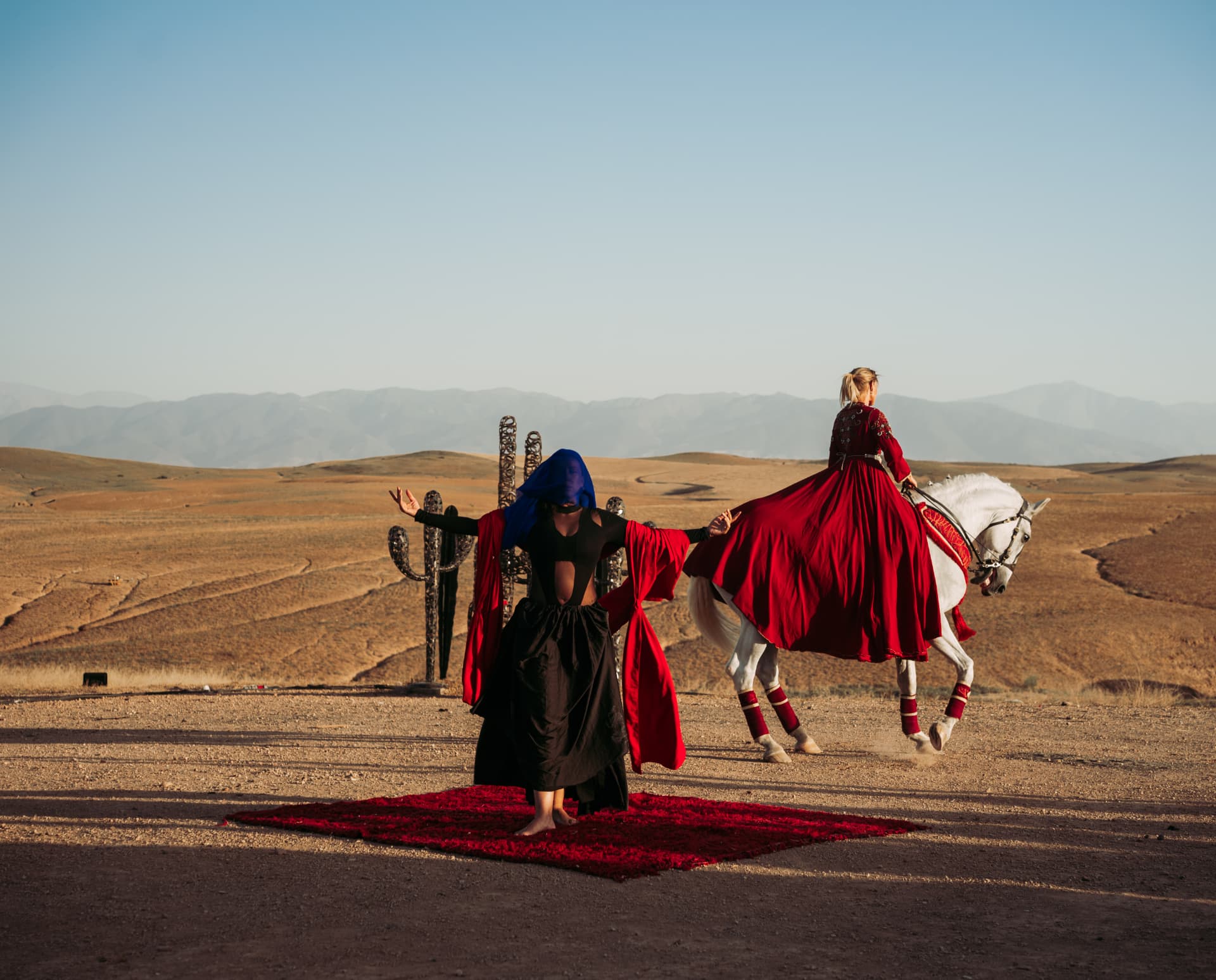 Celebration in the Agafay desert near Marrakech — equestrian performance in red, desert lounges, pampas tablescapes and fireworks, produced by SBAI Events Production