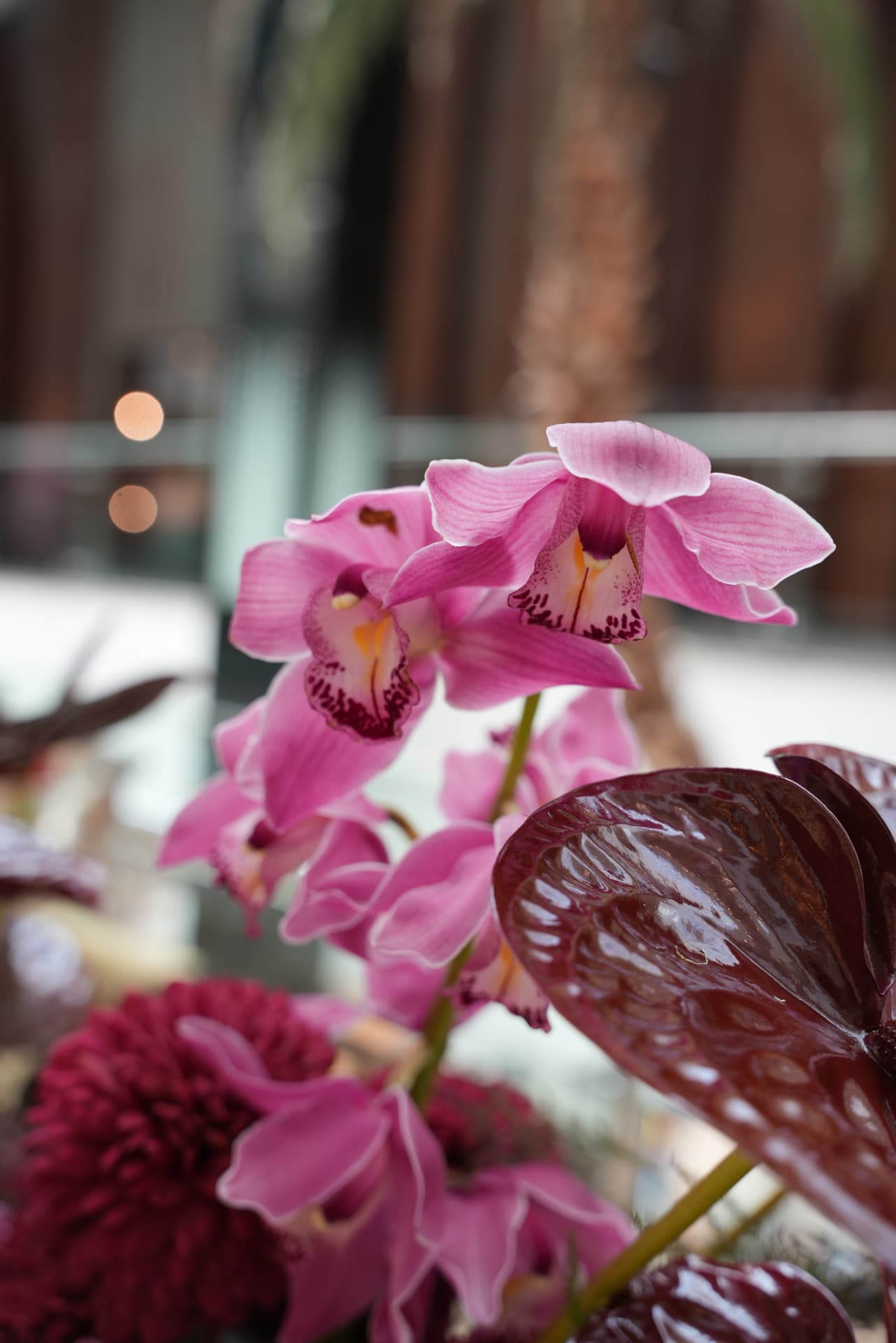 Kara.S boutique opening at Morocco Mall — burgundy anthurium and pink cymbidium installations, silver coupes and brass tables, produced by SBAI Events Production
