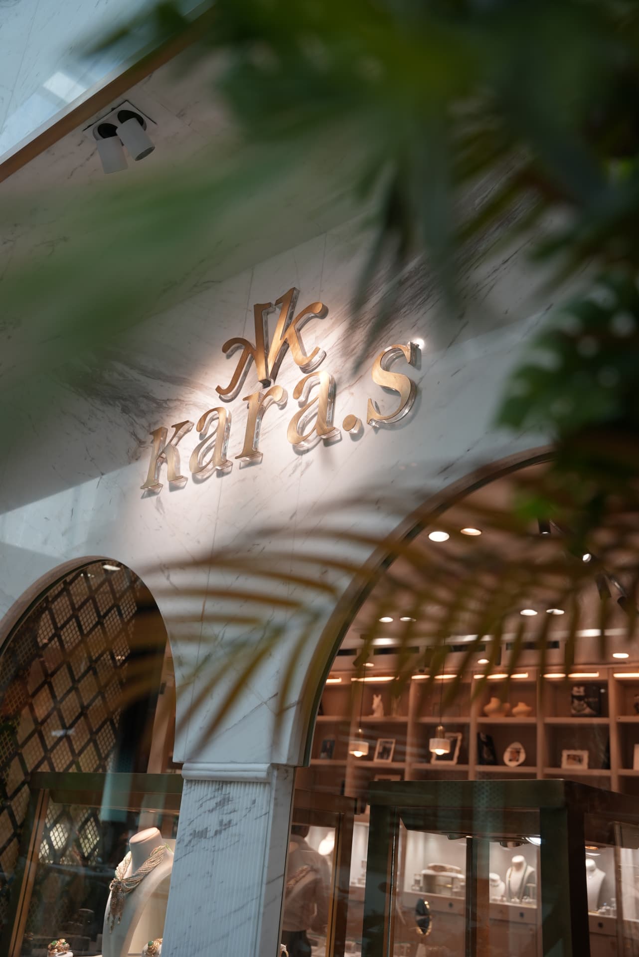 Kara.S boutique opening at Morocco Mall — burgundy anthurium and pink cymbidium installations, silver coupes and brass tables, produced by SBAI Events Production